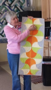 Karen Bean's modern curved piecing and dynamic colors in a table runner.